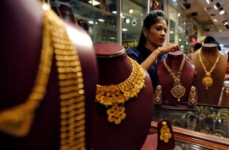 FILE PHOTO: A salesperson attends to a customer (not pictured) inside a jewellery showroom, during Akshaya Tritiya, a major gold-buying festival, in Mumbai, India April 28, 2017. REUTERS/Shailesh Andrade/File photo