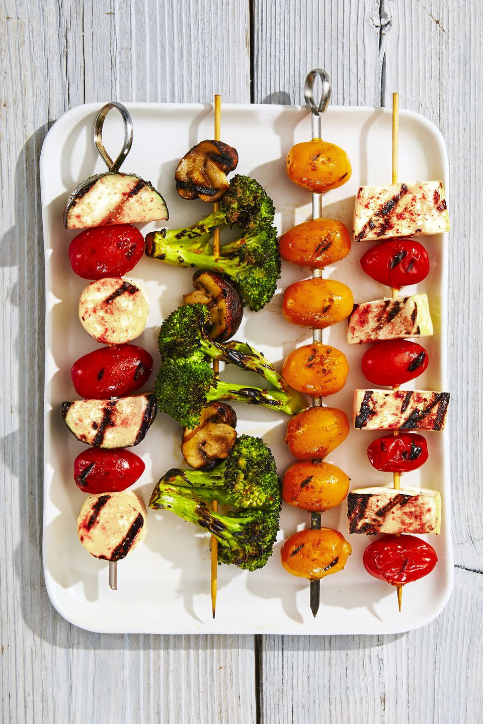 <p>While you're making burgers and hot dogs, toss these seasoned veggies — tomatoes, broccoli, squash and mushrooms — onto the grill. </p><p>Get the <a href="https://www.goodhousekeeping.com/food-recipes/a39273/rainbow-veggie-kabobs-recipe/" rel="nofollow noopener" target="_blank" data-ylk="slk:Rainbow Veggie Kabobs recipe;elm:context_link;itc:0;sec:content-canvas" class="link "><strong>Rainbow Veggie Kabobs recipe</strong></a><em>.</em></p>