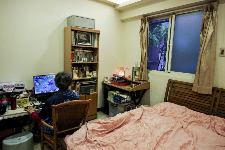 Sixty five-year-old esport player Chiang Yi-Shu(left) practices the League of Legends game at home in New Taipei City, Taiwan on Friday, December 16, 2022. Chiang is one of the League of Legends players on Hungkung Evergreen Gaming's team, established this summer. The team, whose members range from 62 to 69 years old, was founded by Huang Jianji, the director of the department of Multimedia Game development and application of Hungkuang University. They competed in their first-ever video game tournament Saturday at the university. (AP Photo/I-Hwa Cheng)