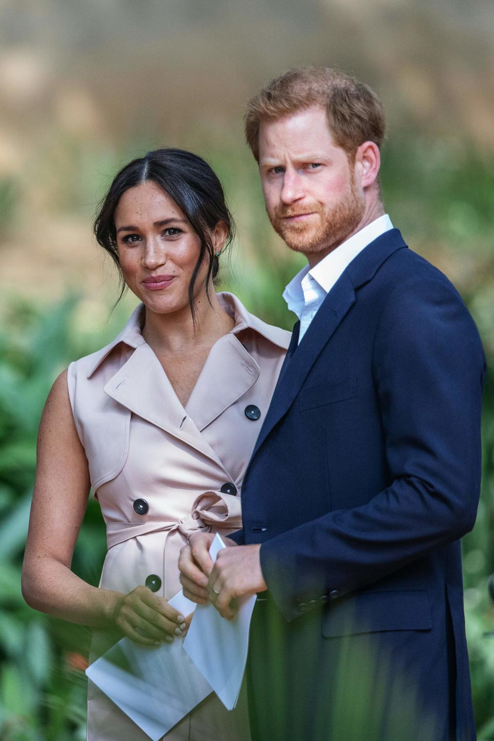 Britain's Prince Harry, Duke of Sussex(R) and Meghan, the Duchess of Sussex(L) arrive at the British High Commissioner residency in Johannesburg where they  will meet with Graca Machel, widow of former South African president Nelson Mandela, in Johannesburg, on October 2, 2019. - Prince Harry recalled the hounding of his late mother Diana to denounce media treatment of his wife Meghan Markle, as the couple launched legal action against a British tabloid for invasion of privacy. (Photo by Michele Spatari / AFP) (Photo by MICHELE SPATARI/AFP via Getty Images)
