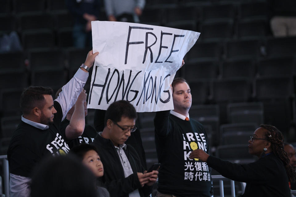 Activists hold up a sign before an NBA exhibition basketball game between the Washington Wizards and the Guangzhou Loong-Lions, Wednesday, Oct. 9, 2019, in Washington. (AP Photo/Nick Wass)