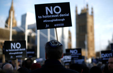 Protesters hold placards and flags during a demonstration, organised by the British Board of Jewish Deputies for those who oppose anti-Semitism, in Parliament Square in London, Britain, March 26, 2018. REUTERS/Henry Nicholls