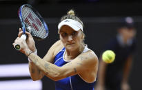 Marketa Vondrousova hits a return during a semifinal match against Ukraine’s Marta Kostyuk at the Porsche Grand Prix tennis tournament, Saturday, April 20, 2024, in Stuttgart, Germany. (Marijan Murat/dpa via AP)