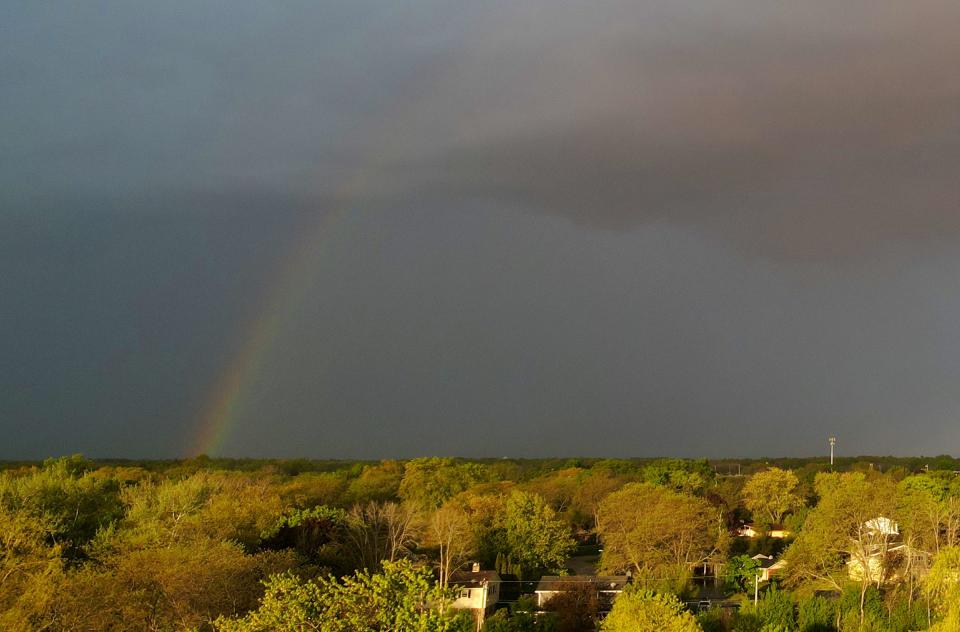 A hint of a rainbow forms as a thunderstorm passes by over Bayside on Monday, May 20, 2024.