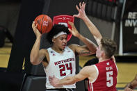 Rutgers' Ron Harper Jr., left, looks to pass the ball as Wisconsin's Tyler Wahl defends during the first half of an NCAA college basketball game Friday, Jan. 15, 2021, in Piscataway, N.J. (AP Photo/Seth Wenig)