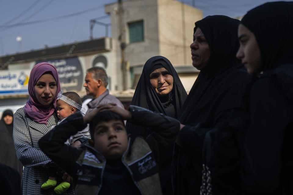 A family heads to the al-Kadhimayn shrine in Baghdad, Iraq, on Saturday, Feb. 25, 2023. For Iraqis, the war and U.S. occupation which started two decades ago were traumatic – an estimated 300,000 Iraqis were killed between 2003 and 2019, according to an estimate by the Watson Institute for International and Public Affairs at Brown University, in addition to some 4,000 Americans. (AP Photo/Jerome Delay)