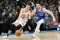 Miami Heat's Tyler Herro (14) drives to the basket against Milwaukee Bucks' Pat Connaughton during the first half of an NBA basketball game Saturday, Feb. 4, 2023, in Milwaukee. (AP Photo/Aaron Gash)