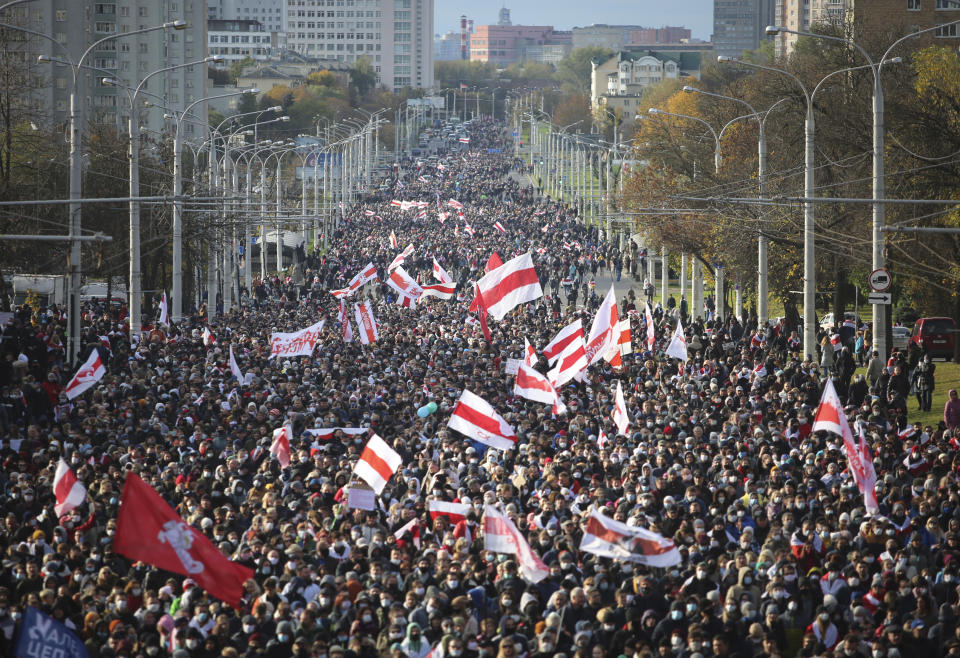 Demonstrators in Minsk wave the former Belarusian flag during a rally to protest the presidential election results on Oct. 18, 2020. 