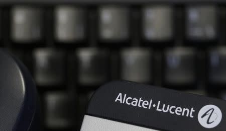 The logo of the telecom equipment maker Alcatel-Lucent is seen on a desk telephone in Paris, April 14, 2015. REUTERS/Christian Hartmann