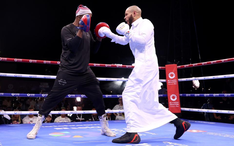 Chris Eubank Jr, wearing a thawb, works out with his trainer Johnathon Banks