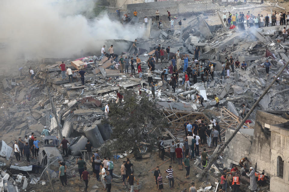 Palestinians inspect the damage of destroyed buildings following Israeli airstrikes on Gaza City, Wednesday, Oct. 25, 2023. (AP Photo/Abed Khaled)