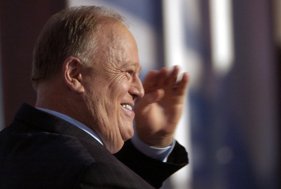 FILE - Former Georgia Senator Max Cleland salutes delegates before introducing Sen. John Kerry at the Democratic National Convention Thursday, July 29, 2004 at the Fleet Center in Boston, Mass. Cleland, who lost three limbs to a Vietnam War hand grenade blast yet went on to serve as a U.S. senator from Georgia, died on Tuesday, Nov. 9, 2021. He was 79. (AP Photo/Ed Reinke, file)