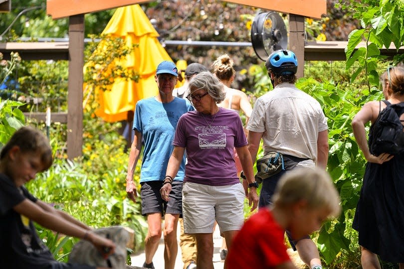 Guests visit Sunny Point Café's garden on July 9, 2023 as part of Bountiful Cities' Urban Garden Tour and Tasting.