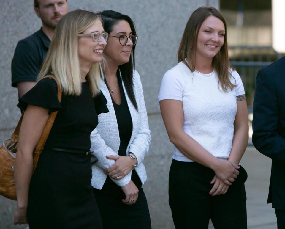 Annie Farmer, left, and Courtney Wild, right, who both say they were molested by Jeffrey Epstein when they were teenagers, faced the wealthy sex offender for the first time in a Manhattan courtroom after his July 2019 arrest. The two women, accompanied by one of attorney Brad Edwards’ assistants, center, listen to Edwards and David Boies, attorneys for Epstein’s accusers, talk to reporters after the hearing. Epstein never faced trial. He was found hanged in his cell a month later.