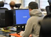 FILE – In this Nov. 23, 2017, file photo, employees of the Competence Call Center (CCC) work for the Facebook Community Operations Team in Essen, Germany. About 500 people control and delete facebook content if it does not apply the Facebook standards in the new center in Essen. Internal company documents from the former Facebook product manager-turned-whistleblower Frances Haugen show that in some of the world's most volatile regions, terrorist content and hate speech proliferate because the company remains short on moderators who speak local languages and understand cultural contexts. (AP Photo/Martin Meissner, File)