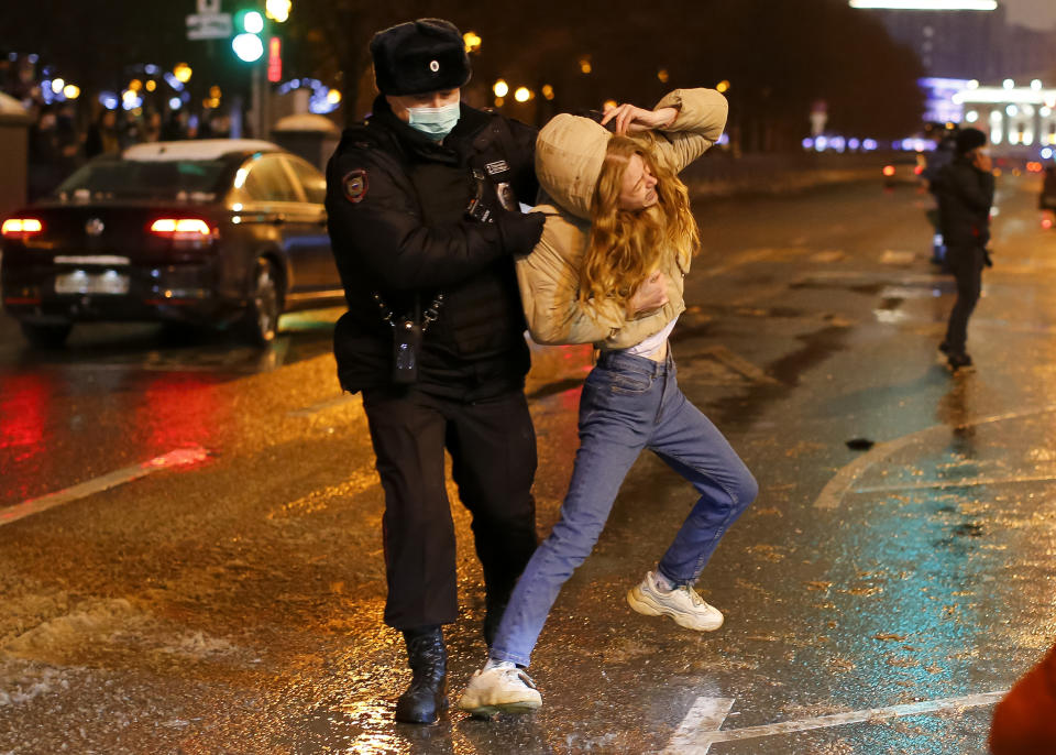 FILE - In this Jan. 23, 2021, file photo, a police officer detains a young woman during a protest against the jailing of opposition leader Alexei Navalny in Pushkin square in Moscow, Russia. Allies of Navalny are calling for new protests next weekend to demand his release, following a wave of demonstrations across the country that brought out tens of thousands in a defiant challenge to President Vladimir Putin. (AP Photo/Alexander Zemlianichenko, File)