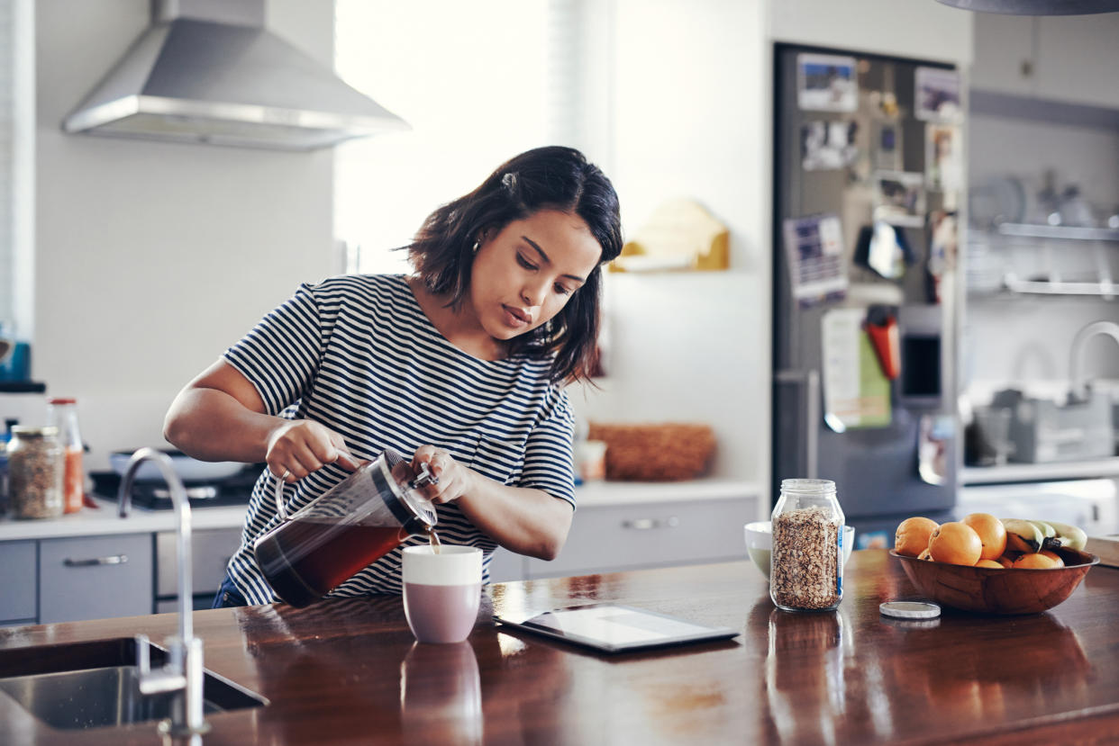 Woman pouring coffee. (Getty Images)