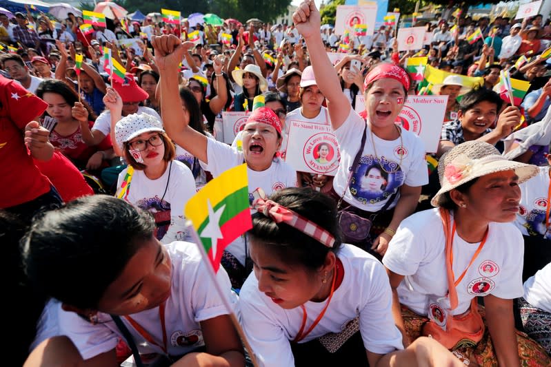 People gather to rally in support of Myanmar State Counsellor Aung San Suu Kyi before she heads off to the International Court of Justice (ICJ), in Yangon