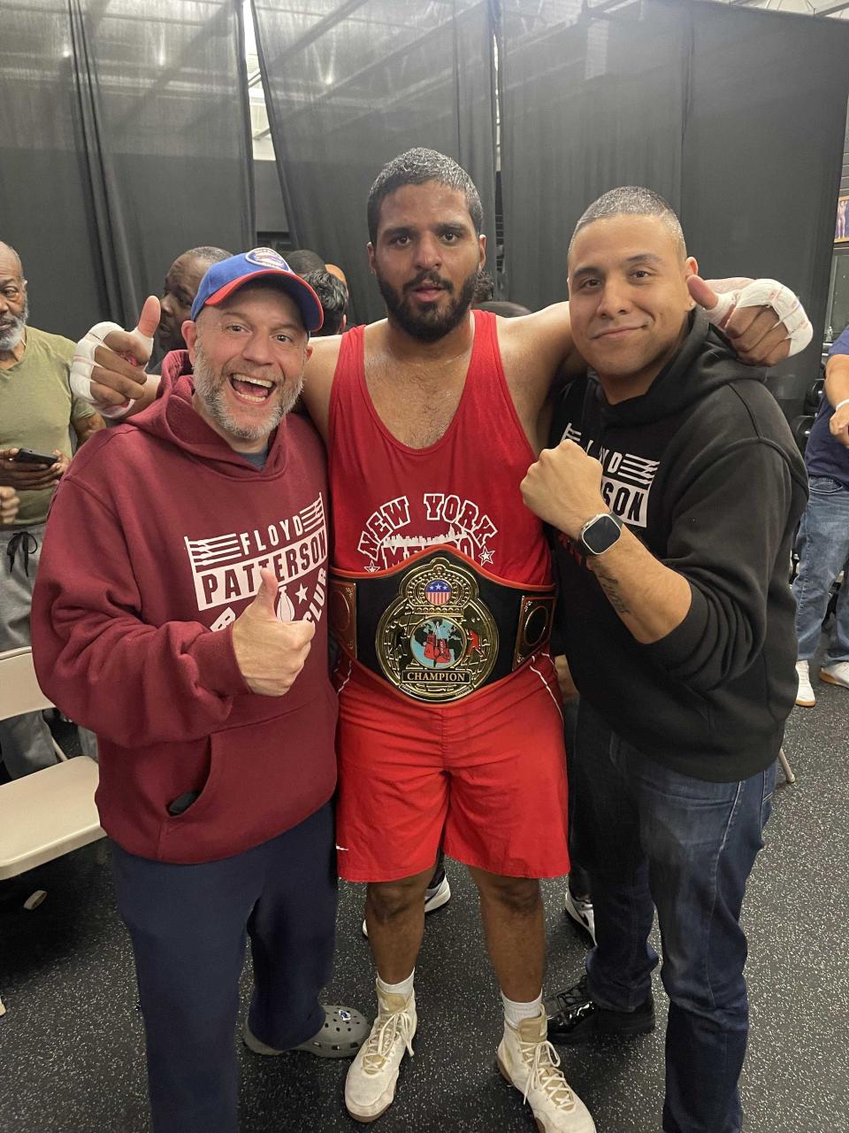 Wappingers Falls resident Miguel Matias poses with his coaches after winning the New York Metro superheavyweight boxing championship on Nov. 5, 2023.