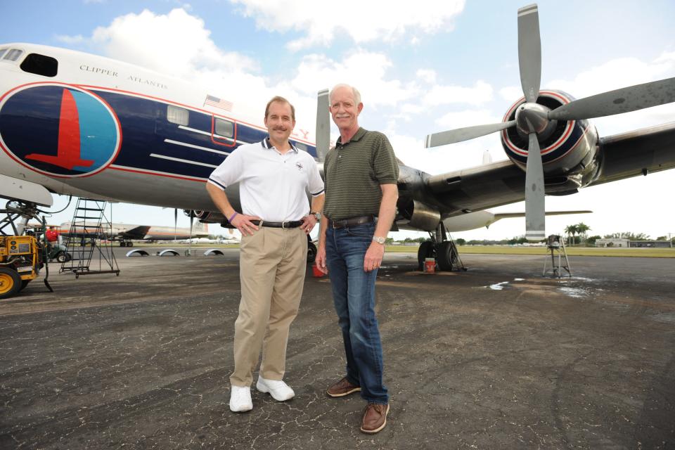 First officer Jeff Skiles and Captain "Sully" Sullenberger pose with the Historical 1958 DC7 to benefit hosted by Historical Flight Foundation on November 17, 2011, in Miami, Florida.