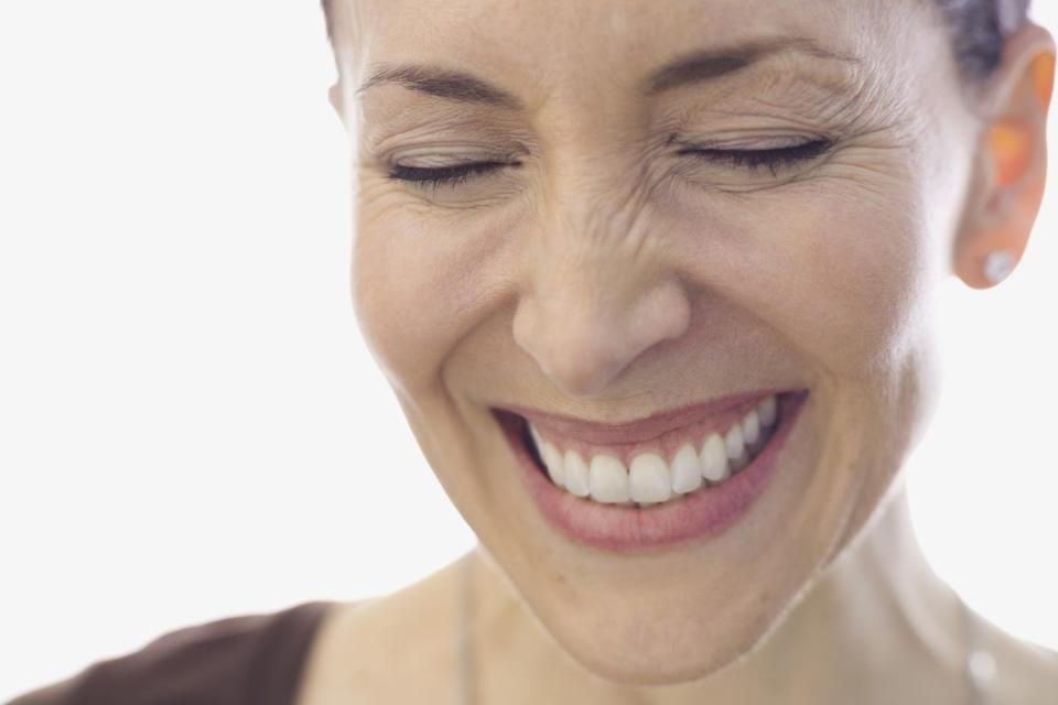Close-up portrait of smiling woman with eyes closed