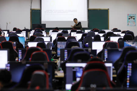 A teacher analyses a role setting procedure during a class of esports and management at Sichuan Film and Television University in Chengdu, Sichuan province, China, November 17, 2017.REUTERS/Tyrone Siu