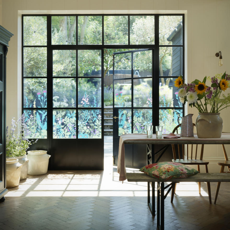 Large windows in living room leading to outdoor space