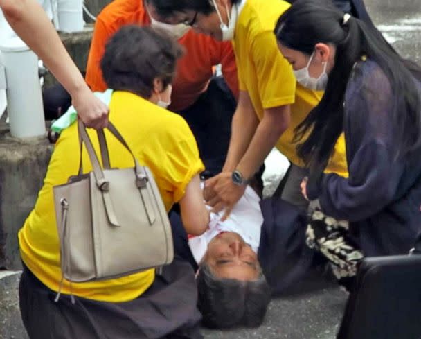 PHOTO: Former Japanese Prime Minister Shinzo Abe lies on the ground after being shot from behind by a man in Nara, western Japan, July 8, 2022. Abe was pronounced dead at a local hospital. (Kyodo/Newscom)