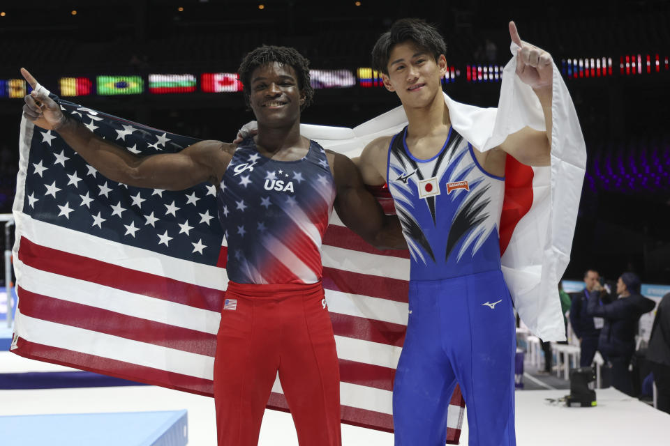 Japan's Daiki Hashimoto, right and gold medal, and United States' Frederick Richard, left and bronze medal, pose after the men's all-round final at the Artistic Gymnastics World Championships in Antwerp, Belgium, Thursday, Oct. 5, 2023. (AP Photo/Geert vanden Wijngaert)