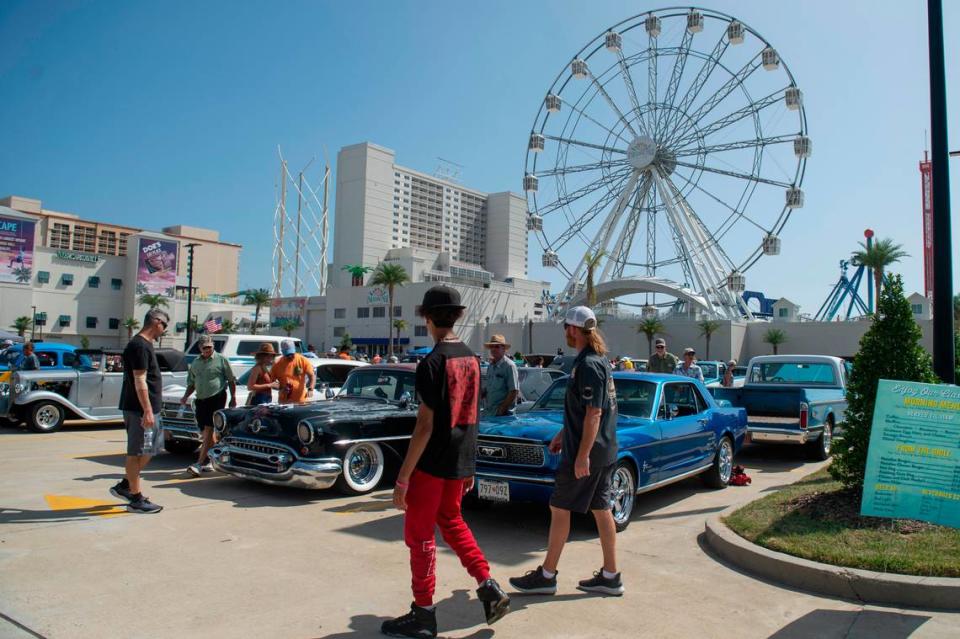 Spectators admire classic cars outside Paradise Pier at Margaritaville Resort Biloxi during Cruisin’ the Coast on Tuesday, Oct. 3, 2023.