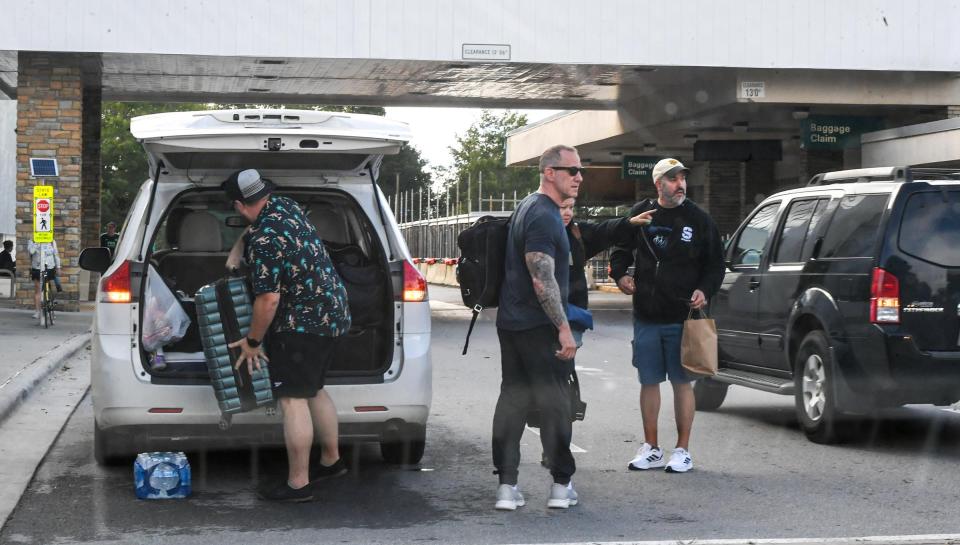 Travelers leave in a taxi from the Asheville Regional Airport Sep 29, 2024; Asheville, NC, USA; during the aftermath of flooding caused by Hurricane Helene. HeleneÕs swath of destruction brought historic rainfall, flooding, power outages and 140-mile-an-hour winds across the Southeast. North Carolina that bore the brunt of damage, with vast swaths of cities like Asheville underwater, residents trapped in their homes with no lights or food and few functioning roads for rescue workers to help them.. Mandatory Credit: Ken Ruinard-USA TODAY