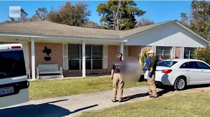 Chambers County Sheriff's Officers in the front yard of a home in Anahuac, Texas, where Christine Rollins was found dead.