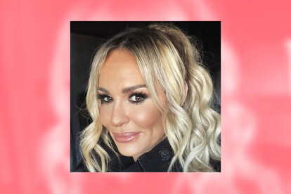 Taylor Armstrong smiling in a selfie overlayed on a pink, blurred, background.