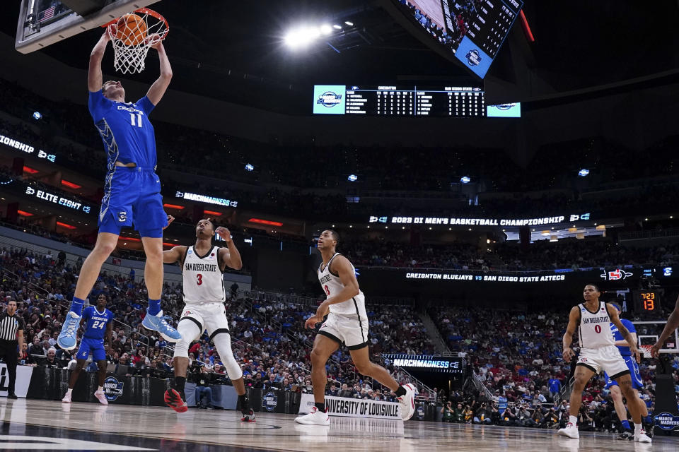 Creighton center Ryan Kalkbrenner (11) dunks the ball against San Diego State in the second half of a Elite 8 college basketball game in the South Regional of the NCAA Tournament, Sunday, March 26, 2023, in Louisville, Ky. (AP Photo/John Bazemore)