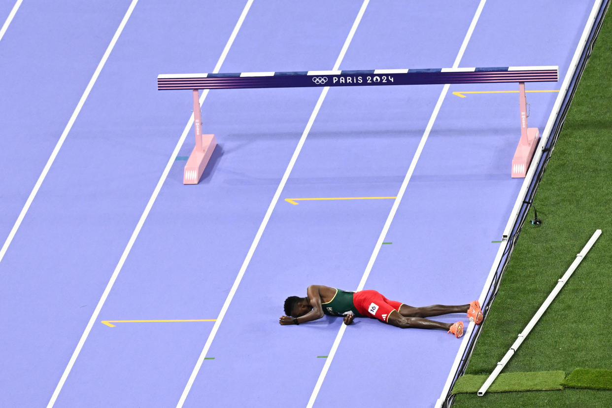 Ethiopia's Lamecha Girma was removed from the Olympic track on a stretcher after hitting his head on a fall during the men's 3,000-meter steeplechase final. (BEN Stansall/AFP via Getty Images)