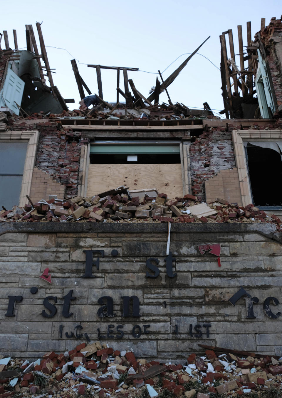 Letters from the First Christian Church signage dangle from the damaged building's facade on Jan. 9, 2022, in Mayfield, Ky. The First Christian Church was one of several downtown churches damaged by a tornado on Dec. 10, 2021. (AP Photo/Audrey Jackson)