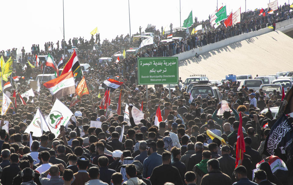 Iraqi mourners gather at the Shaheed (martyr) Mohammed Baqir al-Sadr Bridge, named after Mohammed Baqr Al-Sadr, assassinated during the regime of ousted president Saddam Hussein in the 1980's, as they welcome the body of Abu Mahdi al-Muhandis, the slain chief of Hashed al-Shaabi, an Iraqi paramilitary force with close ties to Iran, in the southern city of Basra after it came from Iran on January 7, 2020 ahead on his burial. - Muhandis, killed early on January 3 in a US strike on Baghdad, was seen as Tehran's man in Iraq and a sworn enemy of the United States. The US strike on Baghdad's international airport early Friday also killed his personal friend Qasem Soleimani, a top commander in Iran's Revolutionary Guard Corps. (Photo by Hussein FALEH / AFP) (Photo by HUSSEIN FALEH/AFP via Getty Images)