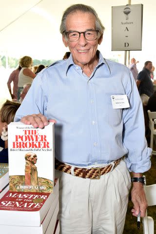 <p>Eugene Gologursky/Getty</p> Robert Caro pictured with 'The Power Broker' book in 2019