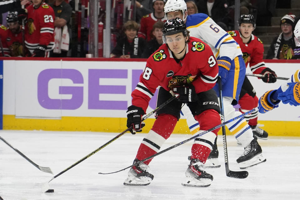 Buffalo Sabres defenseman Erik Johnson (6) defends Chicago Blackhawks center Connor Bedard (98) during the second period of an NHL hockey game Sunday, Nov. 19, 2023, in Chicago. (AP Photo/David Banks)