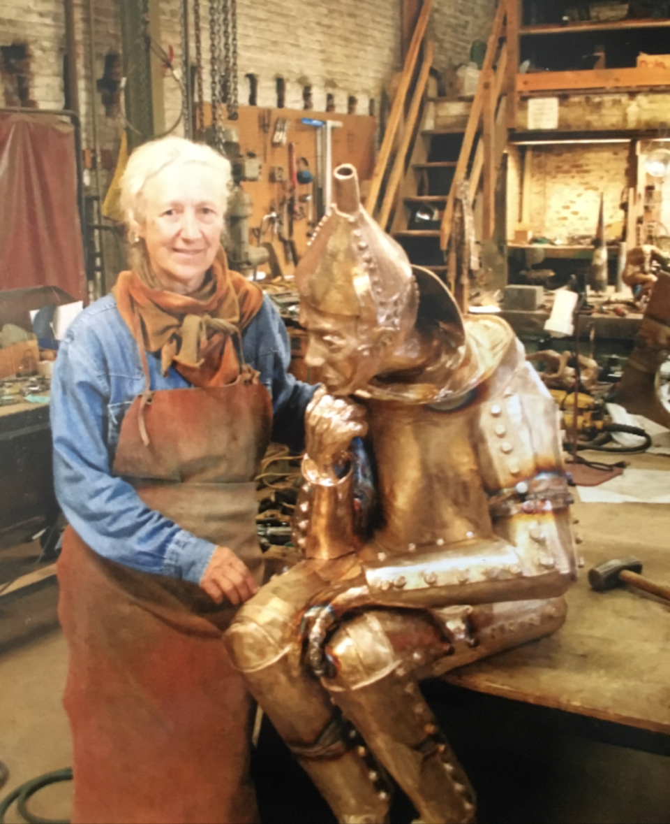 Standing in her Dallastown basement studio, sculptor Lorann Jacobs is seen with her creation, ‘The Tinker,’ one of her best-known sculptures. ‘The Tinker’ sits near the York County Judicial Center in York.