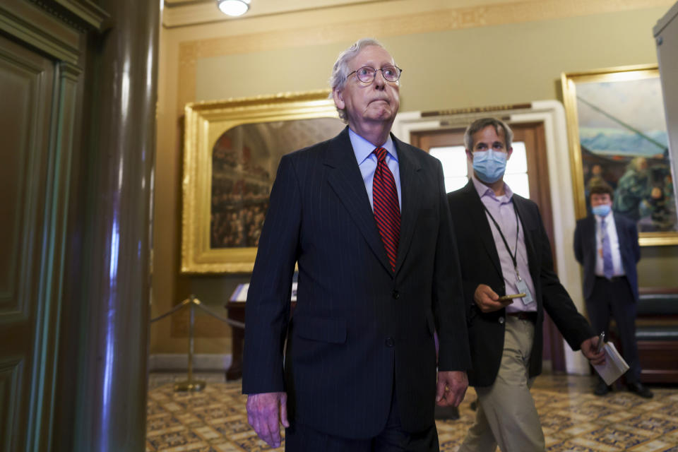 Senate Minority Leader Mitch McConnell, R-Ky., stands after finishing a brief statement to warn that Republicans will block the House-passed measure to keep the government funded and suspend the federal debt limit, at the Capitol in Washington, Wednesday, Sept. 22, 2021. (AP Photo/J. Scott Applewhite)