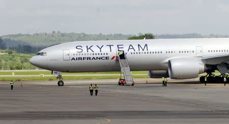 Airport workers are seen near the Air France Boeing 777 aircraft that made an emergency landing is pictured at Moi International Airport in Kenya's coastal city of Mombasa, December 20, 2015. REUTERS/Joseph Okanga