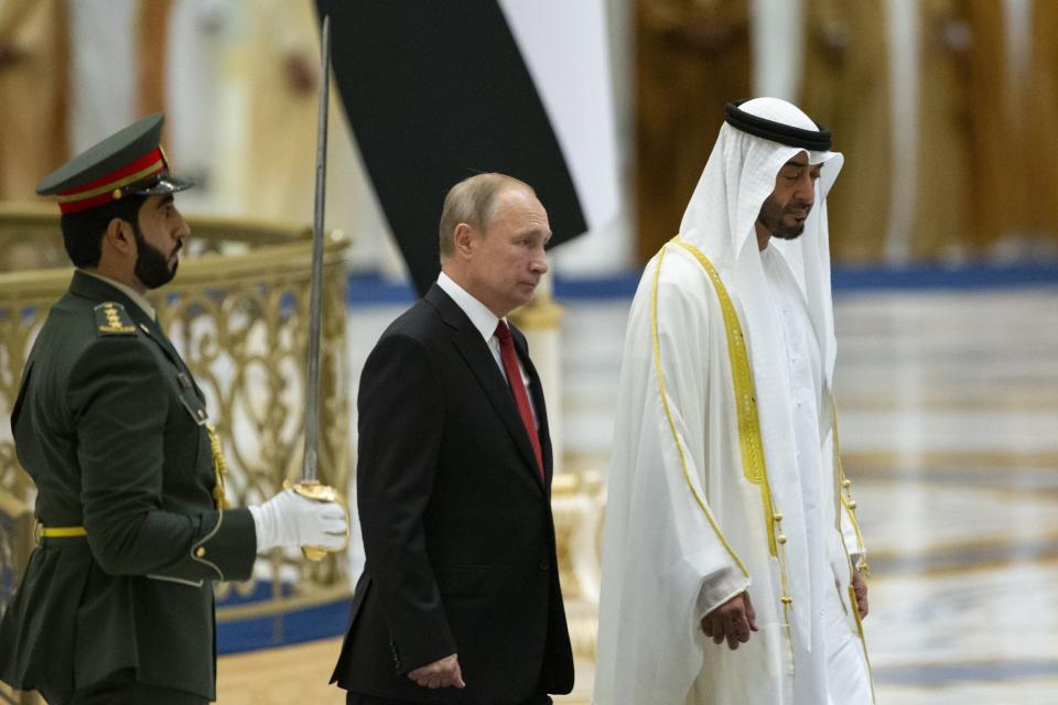 Russian President Vladimir Putin, second left, and Abu Dhabi Crown Prince Mohamed bin Zayed al-Nahyan attend the official welcome ceremony in Abu Dhabi, United Arab Emirates, Tuesday, Oct. 15, 2019. (AP Photo/Alexander Zemlianichenko, Pool)