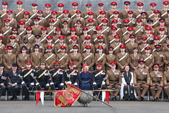 <p>Chris Jackson/WPA Pool/Getty</p> Queen Camilla poses for a group photo during her visit to The Royal Lancers on April 22, 2024 in Catterick, England.