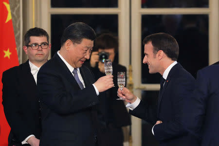 French President Emmanuel Macron and Chinese President Xi Jinping toast during a state dinner at the Elysee Palace in Paris, France March 25, 2019. Ludovic Marin/Pool via REUTERS