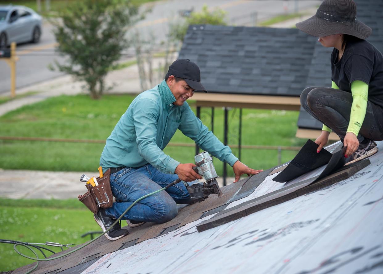 Workers on Thursday, May 27, 2021, repair Nellie Dean's roof, which was destroyed by Hurricane Delta. Dean's roof was replaced after the Knights of Peter Claver #166 collected funds to fix it for her.