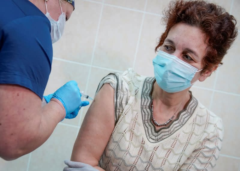 FILE PHOTO: A nurse inoculates a volunteer with Russia's "Sputnik-V" vaccine against the coronavirus disease (COVID-19) in a post-registration trials stage at a clinic in Moscow