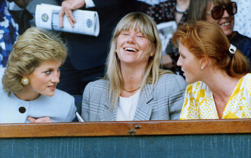 Princess Diana leans over Katie Menzies to hear the Duchess of York at Wimbledon (1989) - Credit: AP.