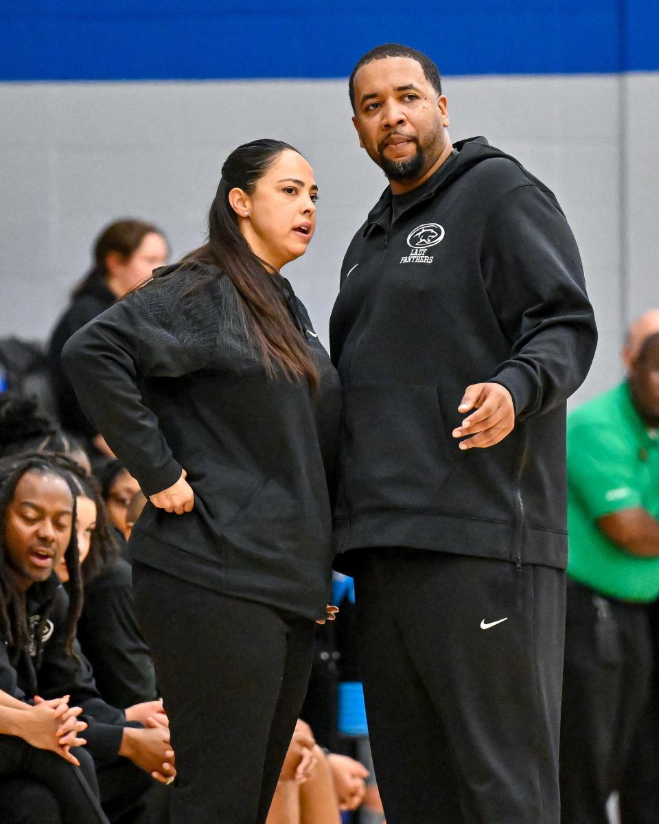 Washington Panthers assistant coach Marcy Reynolds and head coach Steven Reynolds Jr. talk in the first half of the game against Marian Friday, Nov. 11, 2022, at Marian High School.