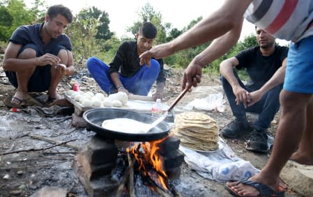 Migrants make breakfast in camp Vucjak in Bihac